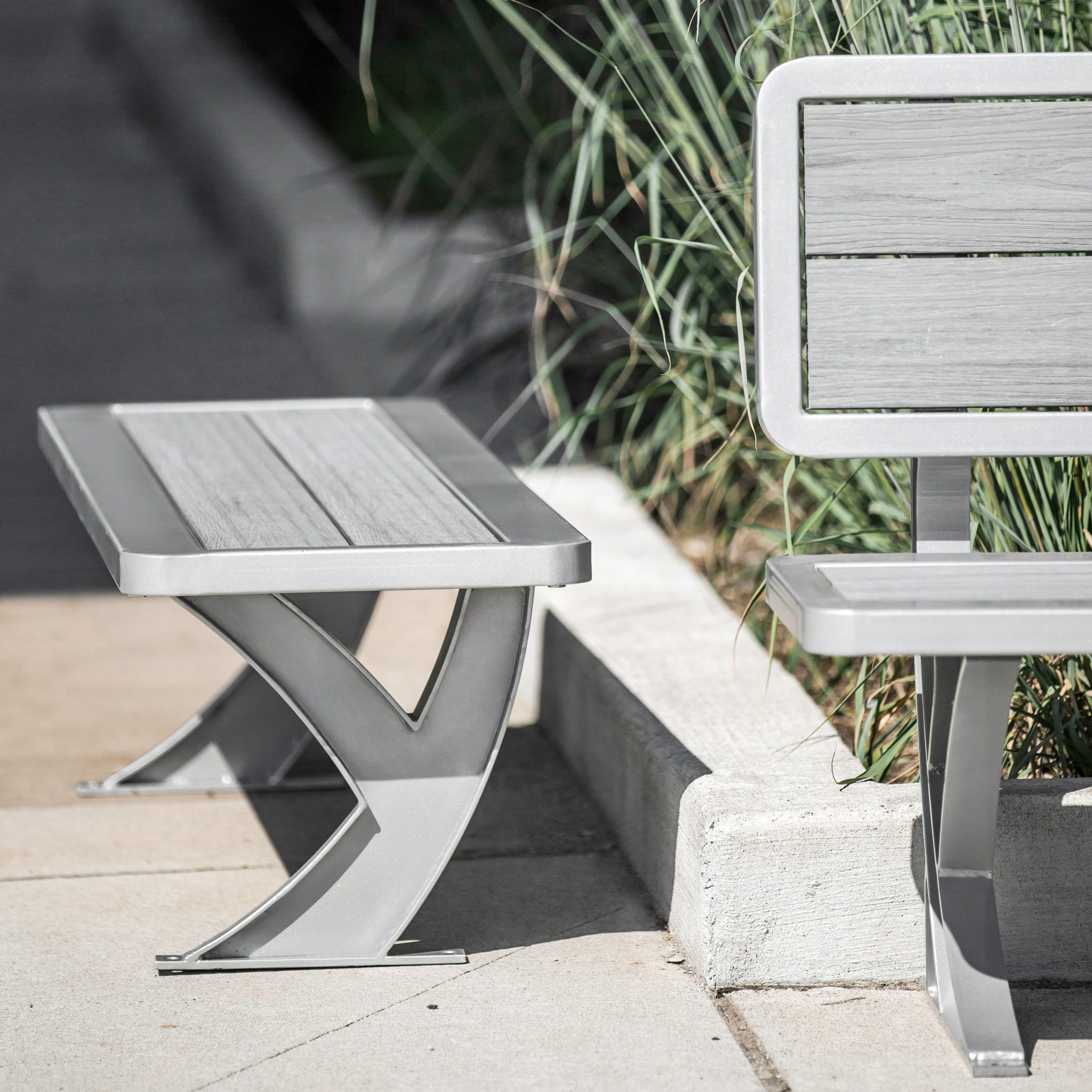 silver backless street patio bench constructed with recycled plastic and metal frame