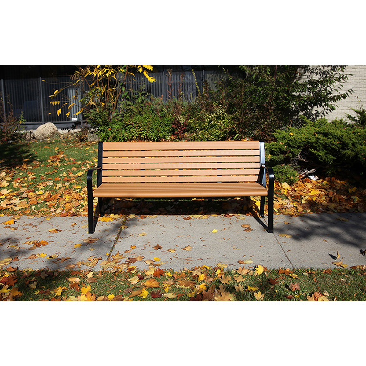 a commercial recycled plastic outdoor garden bench in a golden harvest season afternoon. It is a great commemorative park bench too