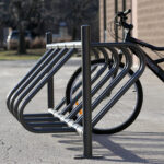 the public bike racks for parking is in service outside the apartment building