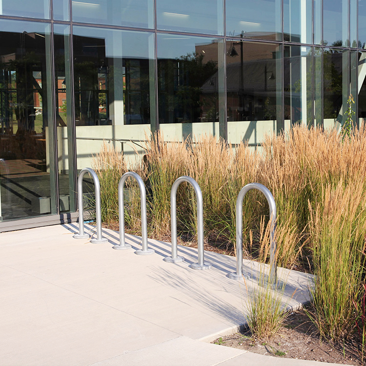 custom colored outdoor bike parking racks are installed outside the community library
