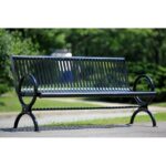 the metal garden bench/ steel park bench is waiting for its passersby in the park