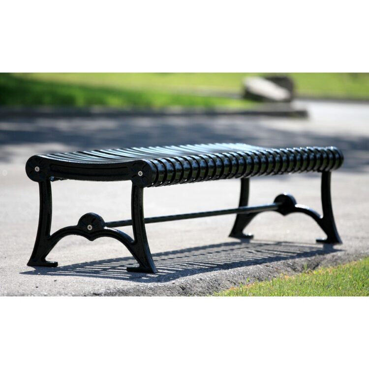 backless steel garden bench on a sidewalk in a park