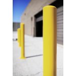 sharp yellow-colored parking steel bollards doing their job outside a warehouse
