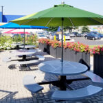 steel outdoor commercial garden picnic tables installed outside IKEA embraced by pretty flowers