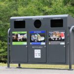 commercial outdoor trash and recycling station with custom labels is doing its job in the park