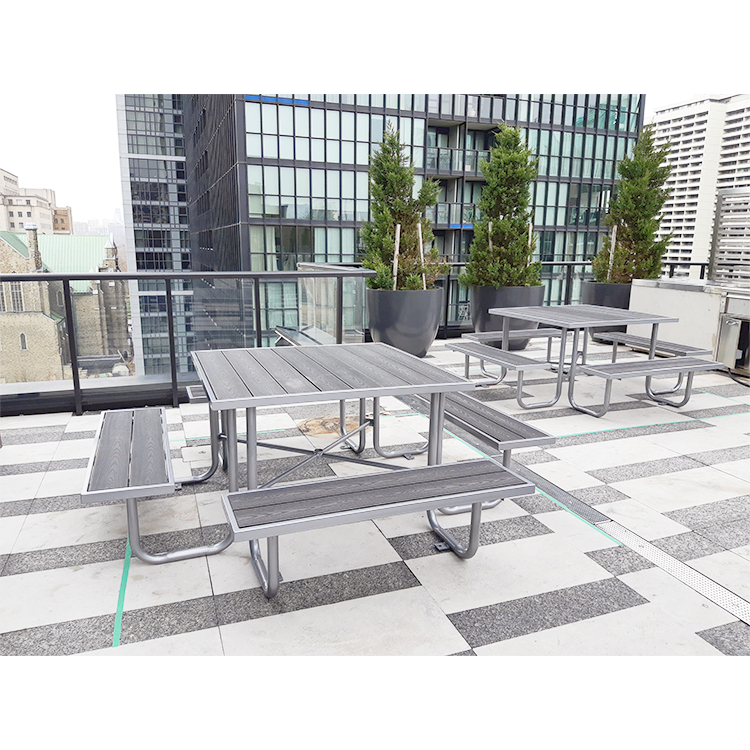 2 metal frame commercial square recycled plastic lumber picnic tables are installed on the rooftop patio of the building