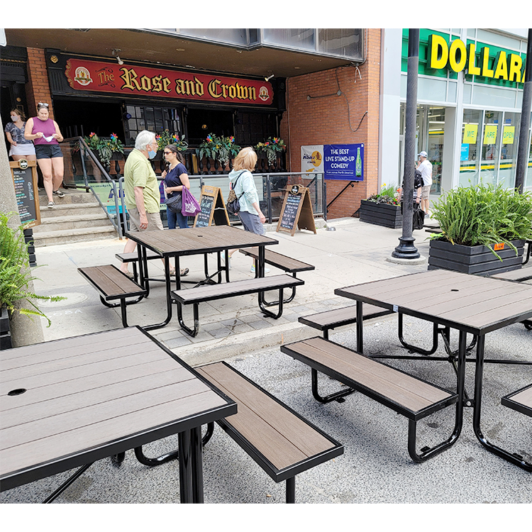 dark brown square dining picnic tables at the restaurant patio area are made of recycled plastics and steel