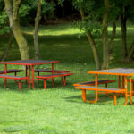 2 recycled plastic patio picnic tables are built with custom frame colors look like 2 beautiful flowers on the fresh grasses