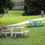 commercial patio picnic tables for dining located outside of a community center