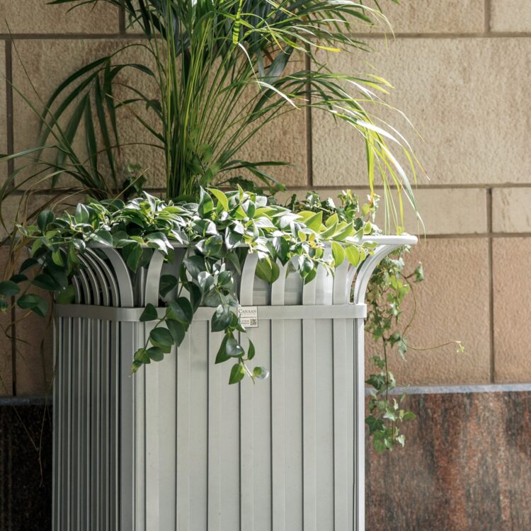 a silver metal park planter with greeneries in it