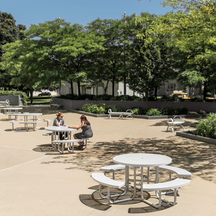 4 steel park patio tables are located in a street park