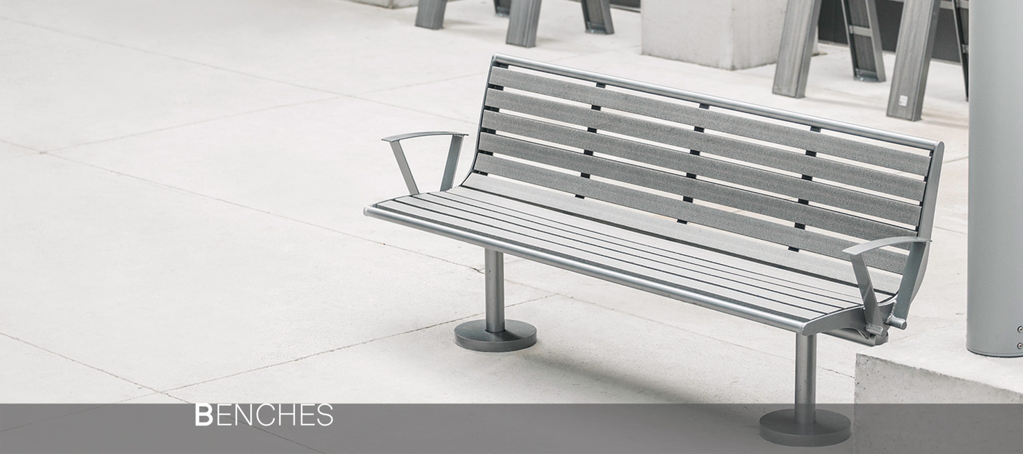 smoothly arced commercial recycled plastic bench that is compatible in a variety of outdoor environments.