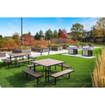 An inviting outdoor setting with picnic table Park Dining Table CAT-201N-a, nestled in a lush grassy area and BBQ patio