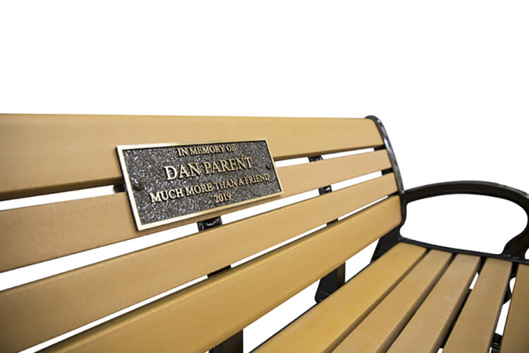 metal memorial plaques on a recycled plastic memorial bench