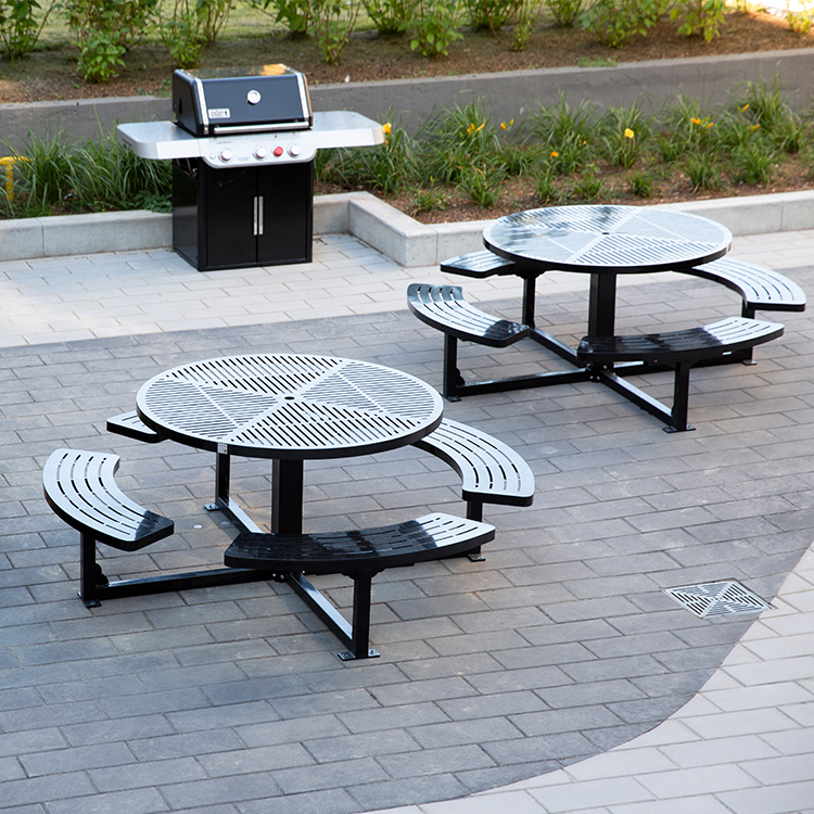 Metal Park Picnic Table CAT-208 and chairs arranged in a courtyard, providing a comfortable outdoor seating area.