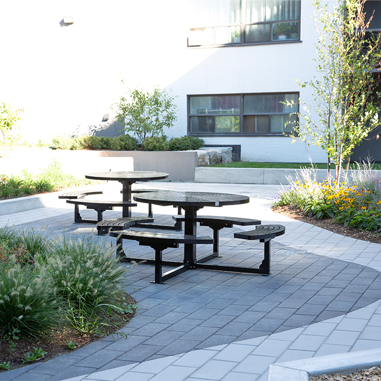 Metal Park Picnic Table CAT-208 and chairs arranged in a courtyard, providing a comfortable outdoor seating area.